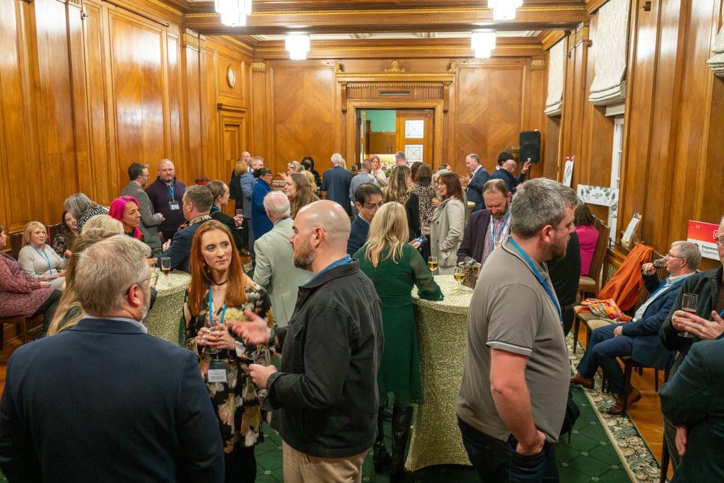 Ards Business Hub Jingle and Mingle 2025 guests socialising in Stormont Parliament Buildings Member's Dining Room.